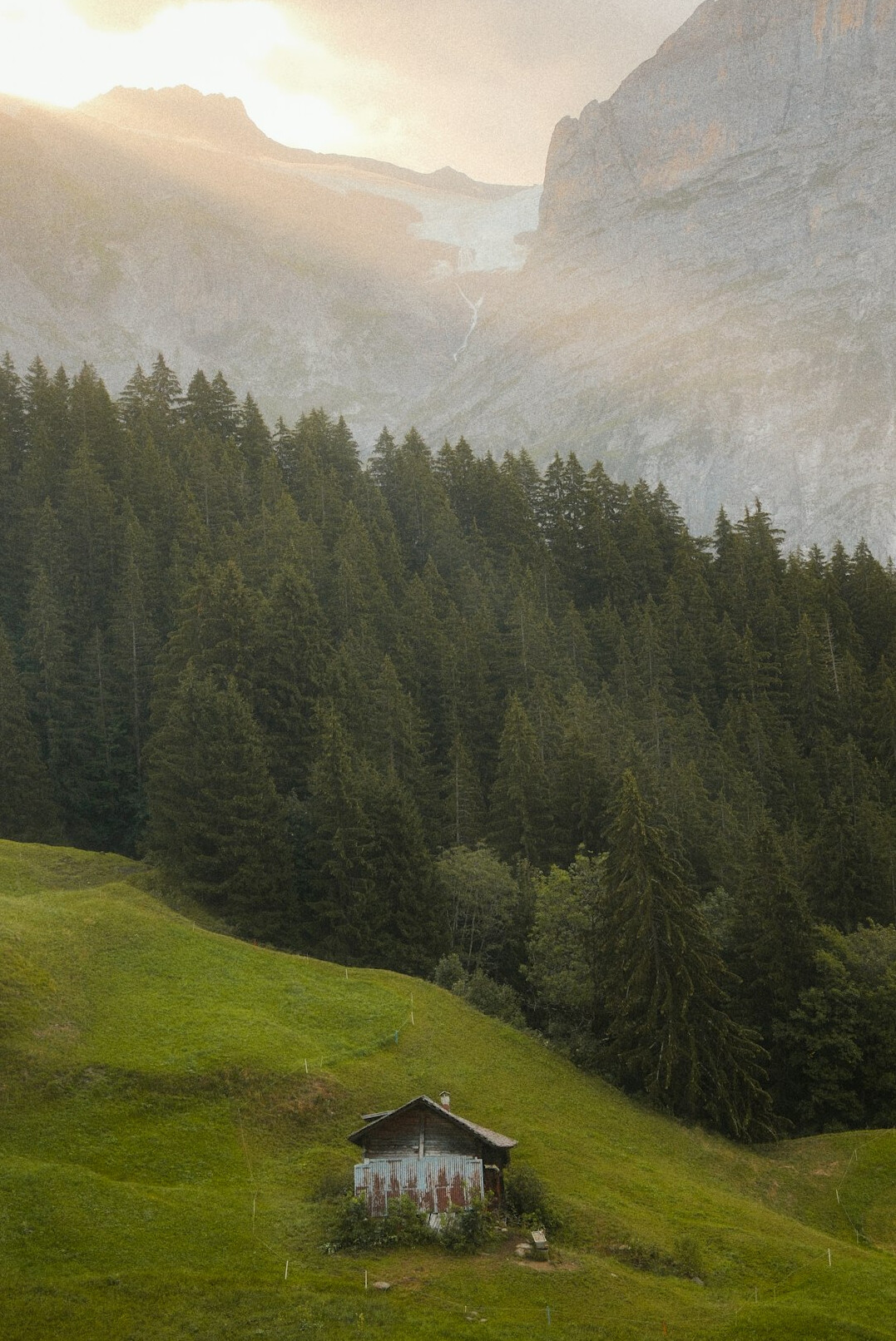 Luxury Swiss chalet exterior in the mountains at golden hour